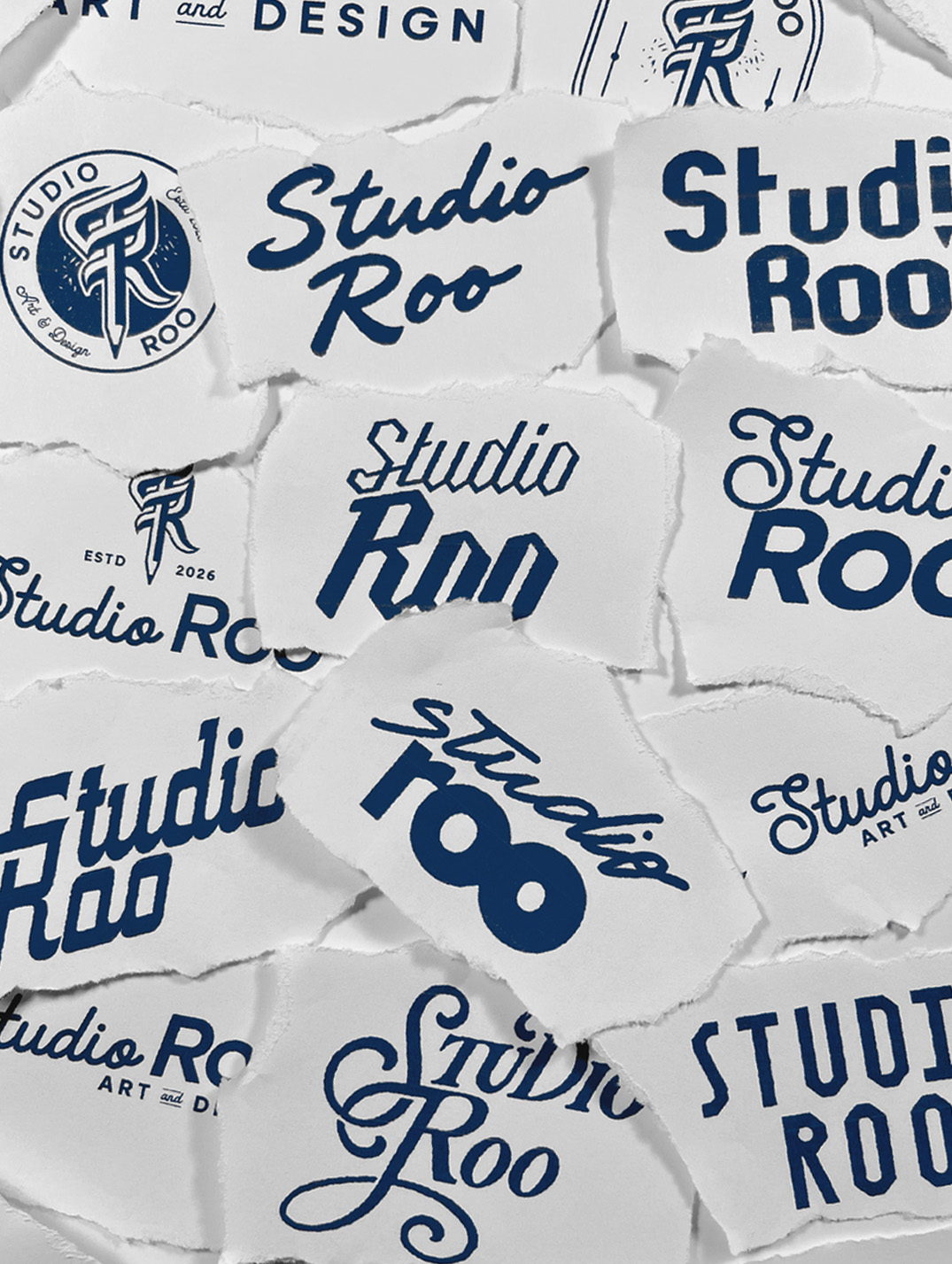 Torn paper scraps showing hand-lettered Studio Roo logo variations