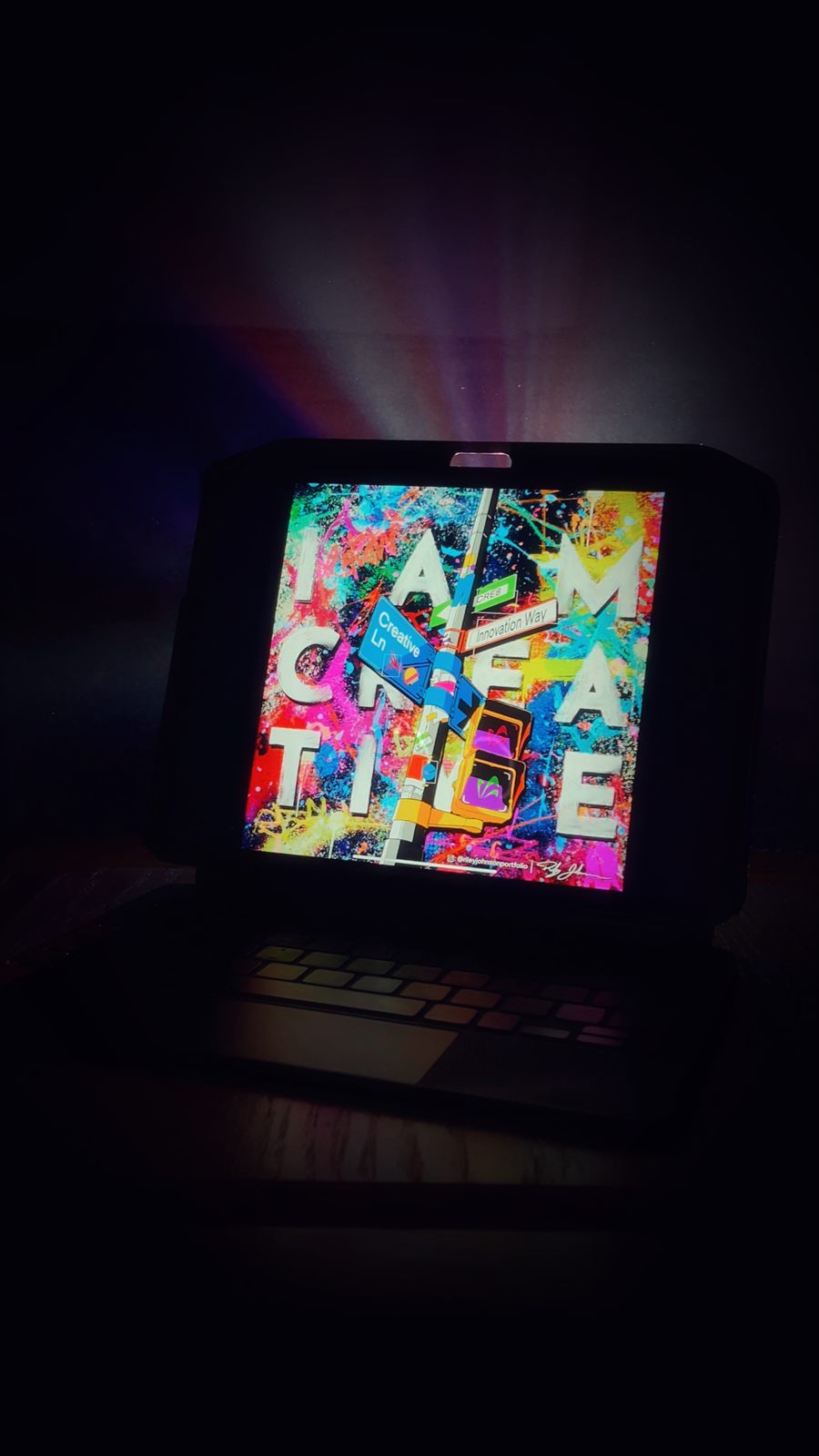 The finished digital illustration of the mural glowing on a screen in a dark room