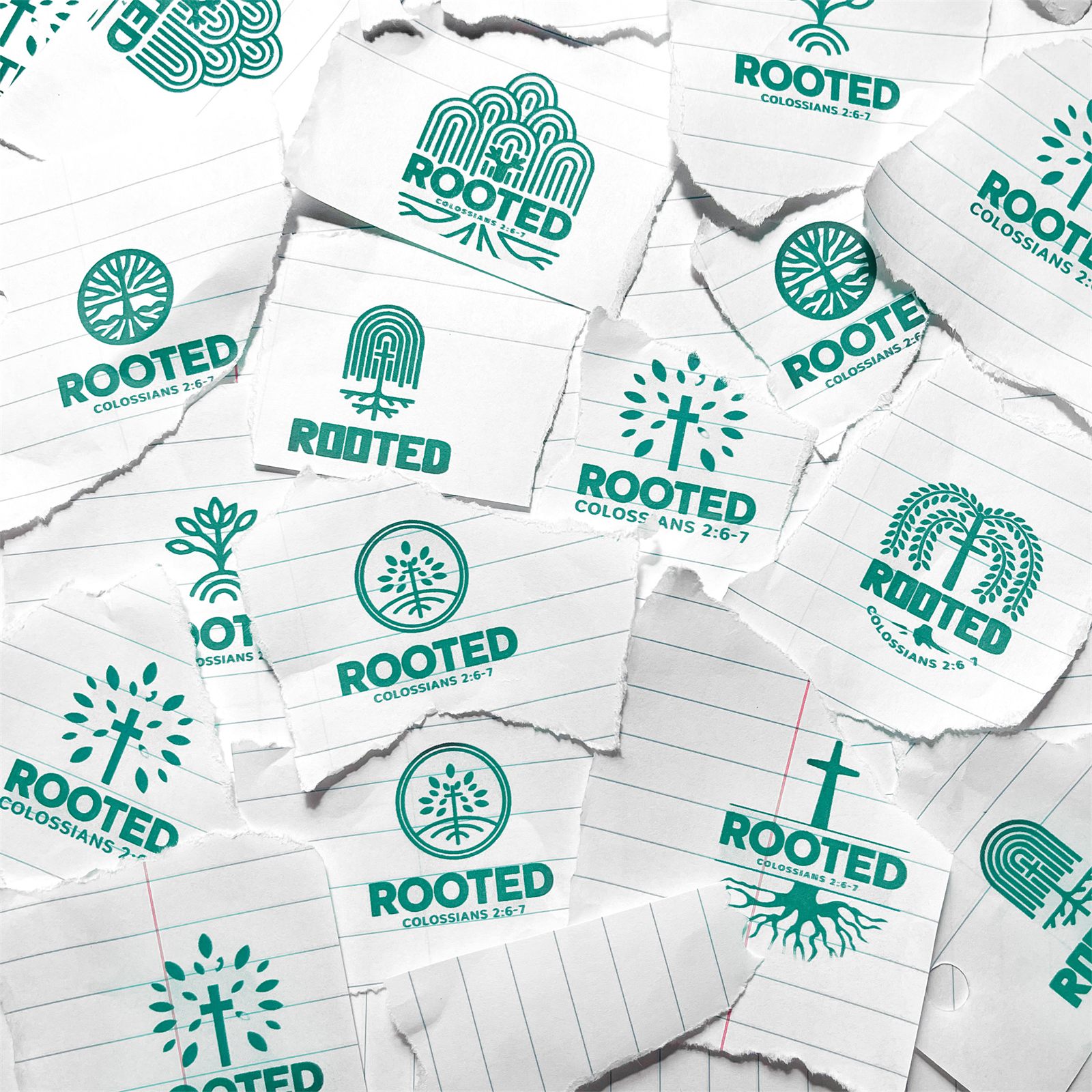 A collage of torn notebook paper scraps, each printed with a different green Rooted logo sketch exploring trees, roots, and crosses