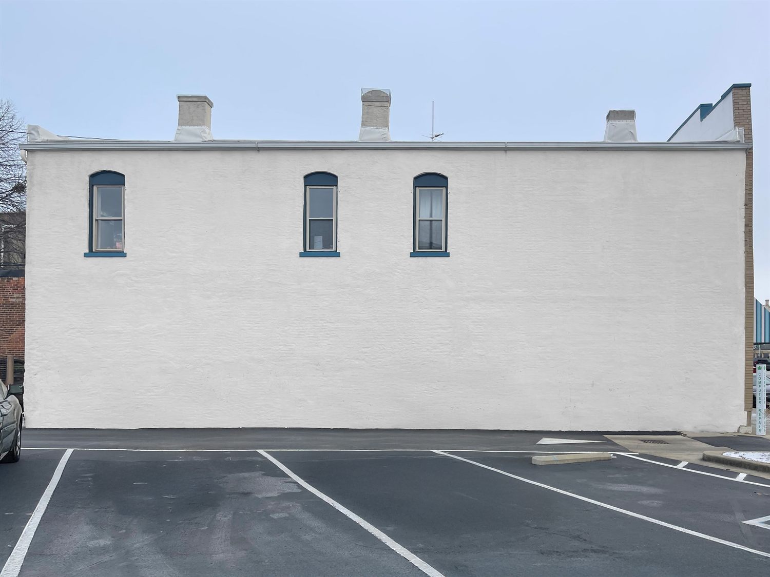 The downtown wall before the mural, a plain surface facing the street