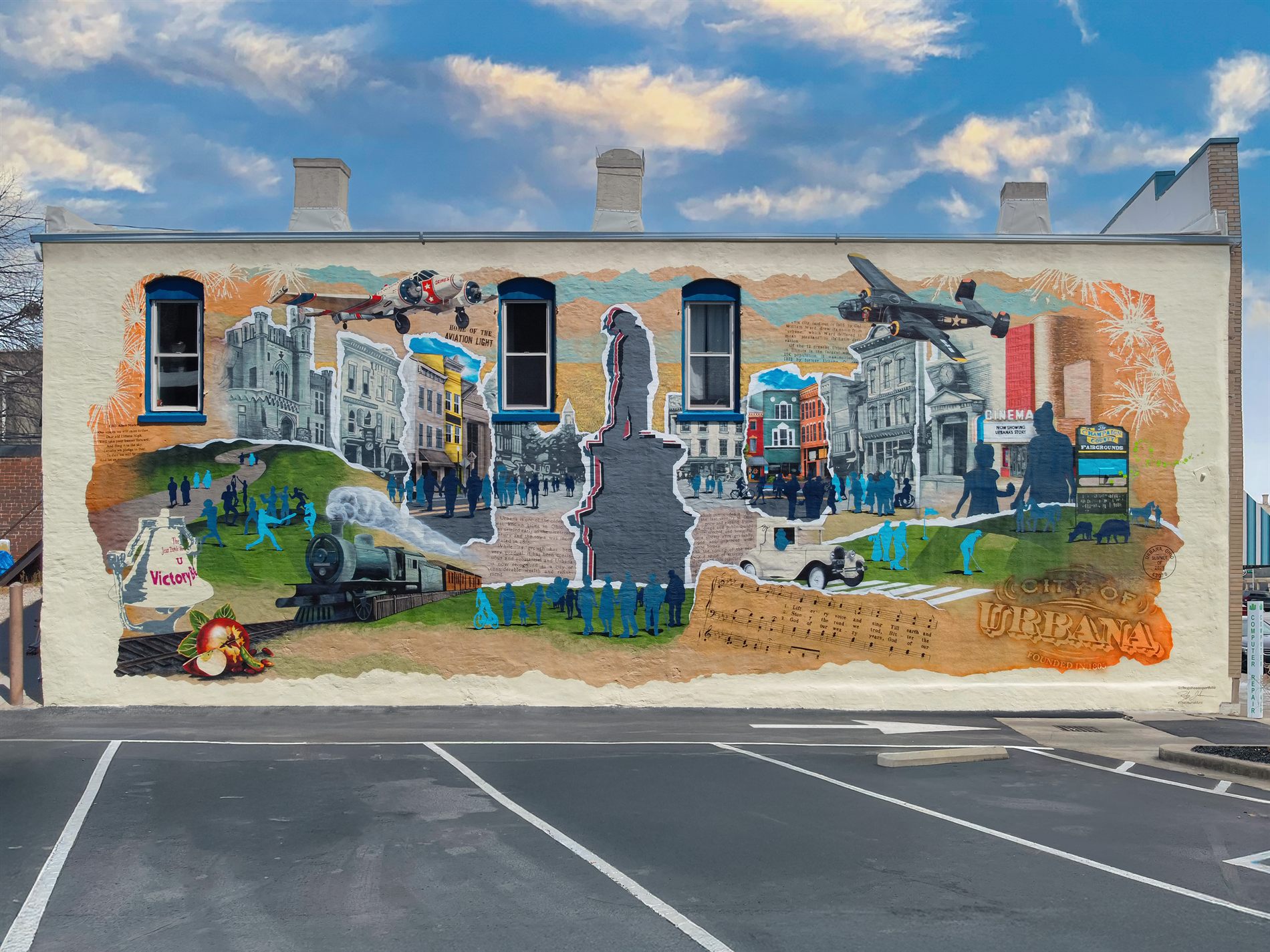 The same wall after, covered by the finished Urbana Mural